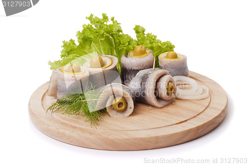 Image of A composition with marinated herring rolls