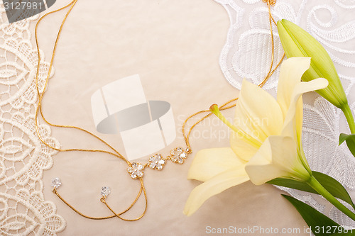 Image of Chain and lily on lace background