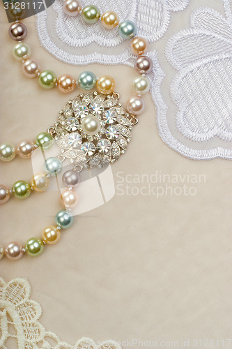 Image of Necklace with brooch on lace background