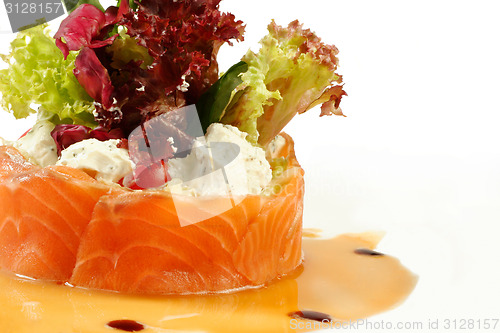 Image of Salmon under sour cream closeup