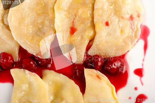 Image of Ukrainian national dish varenyky (ravioli) with cherry closeup