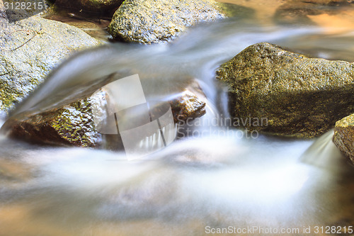 Image of waterfall and rocks covered with moss