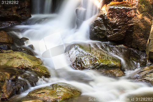 Image of waterfall and rocks covered with moss