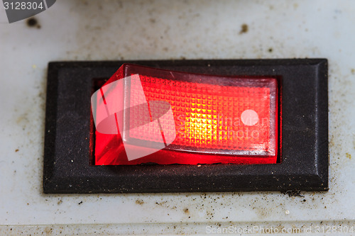 Image of device panel with detailed red power switch button 