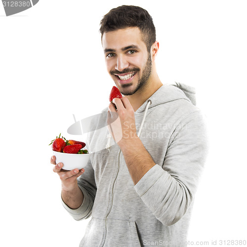 Image of Happy young eating a strawberry