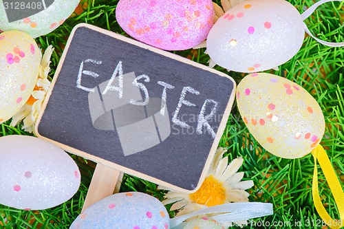 Image of Easter eggs with chalkboard on the grass