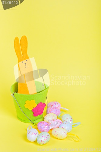 Image of Easter Bunny in bucket on yellow