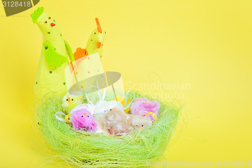 Image of Easter eggs in nest and chickens