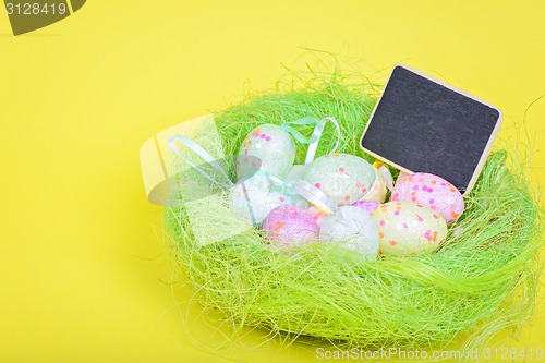 Image of Ester eggs in nest with copy-space blackboard