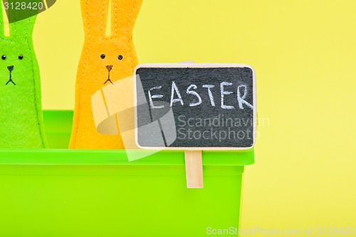 Image of Easter Bunnies in flower pot with black board