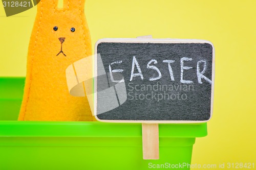 Image of Easter Bunny in flower pot with blackboard