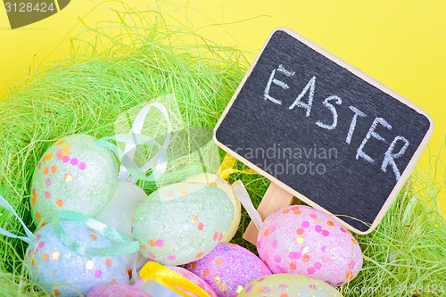 Image of Ester eggs in nest with copy-space chalkboard