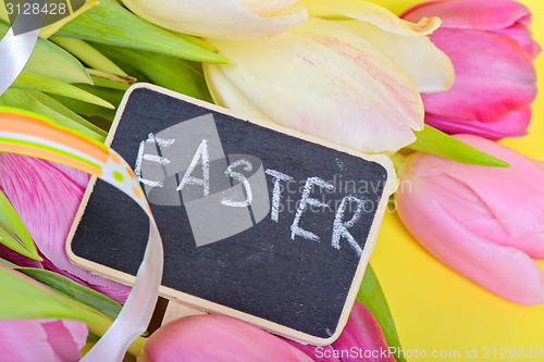 Image of Easter ribbon, tulips and small blackboard