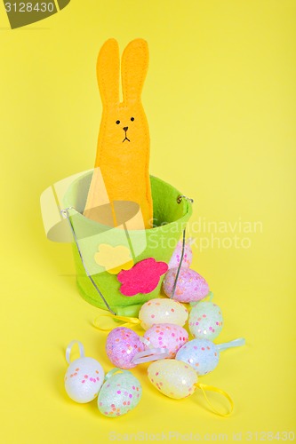 Image of Easter rabbit in bucket on yellow