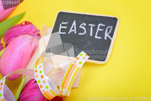 Image of Easter ribbon, tulips and small chalkboard