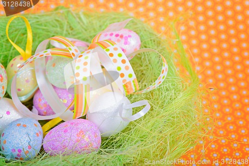 Image of Easter ribbon and eggs in nest 