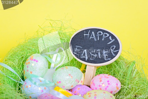 Image of Ester eggs in nest with small blackboard