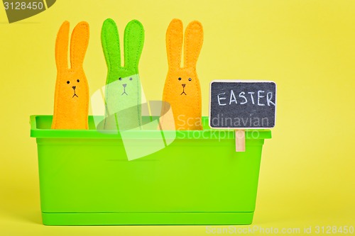 Image of Easter Bunnies in flower pot with blackboard