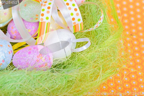 Image of Easter eggs and ribbon in nest 
