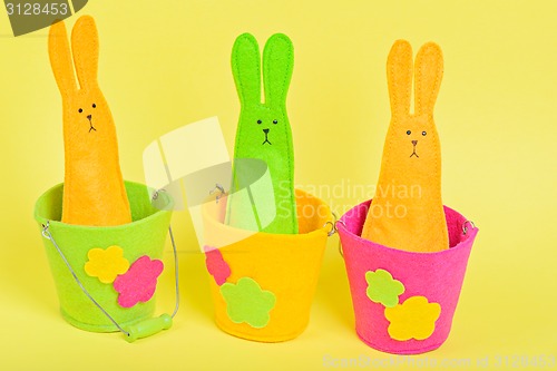 Image of Three easter Bunnys in buckets on yellow