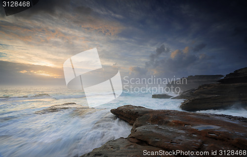 Image of Wild ocean surges over steadfast rocks