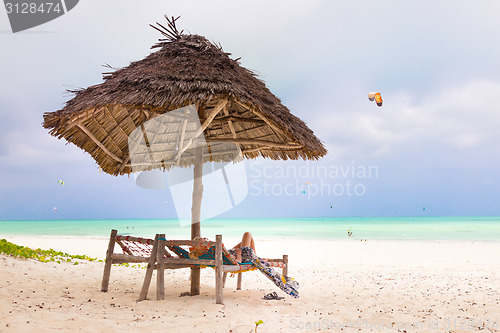 Image of Woman sunbathing on tropical beach.