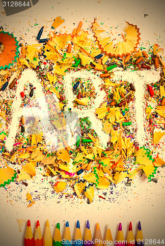 Image of ART word on the background of colored shavings