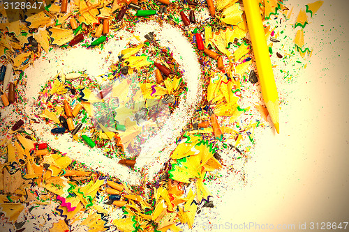 Image of heart, yellow pencil and wood shavings