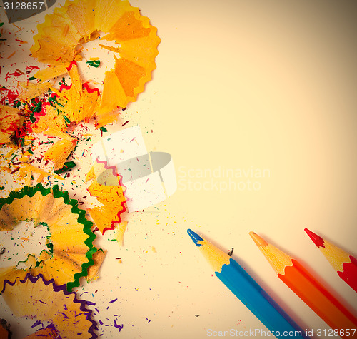 Image of colored pencils and shavings on white background