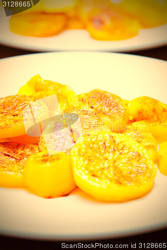 Image of slices of baked potatoes on a white plate