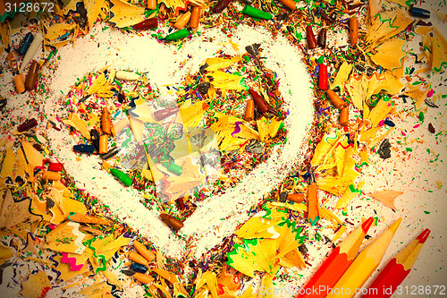 Image of heart, multicolored pencils and varicolored shavings