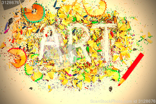 Image of ART word on the background of pencil shavings