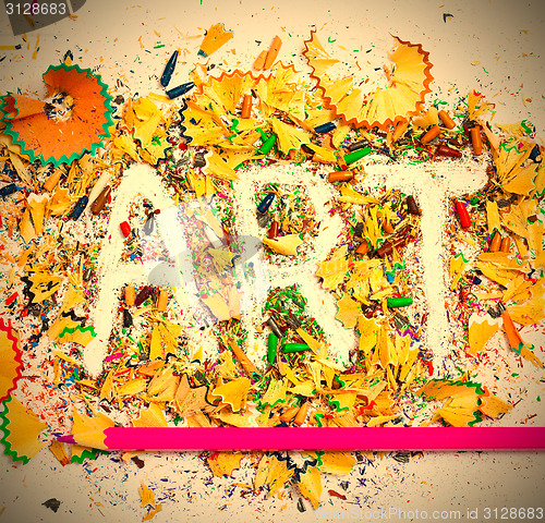 Image of ART word on the background of colored pencil shavings