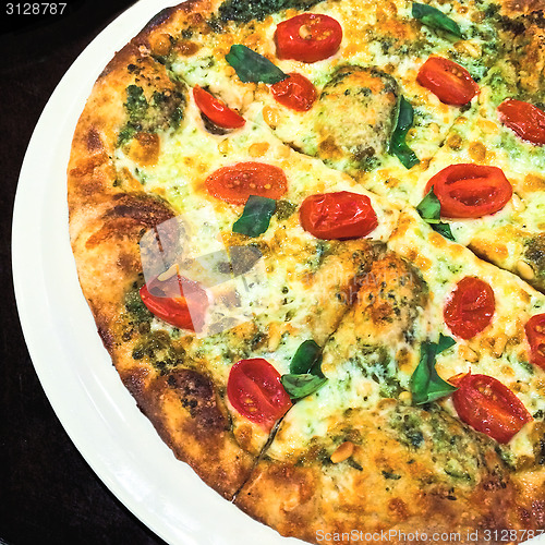 Image of Pizza with white cheese, tomatoes and herbs