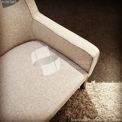 Image of Beige textile armchair on a carpet