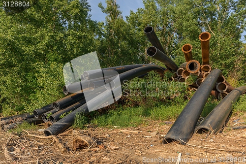 Image of Rusty metal pipes in the forest