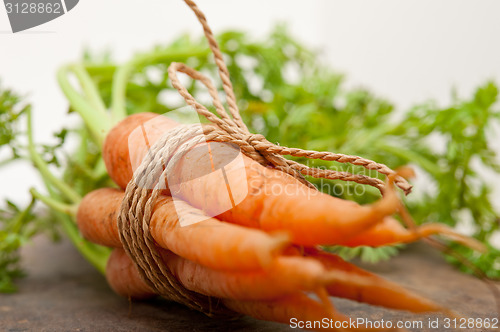 Image of baby carrots bunch tied with rope
