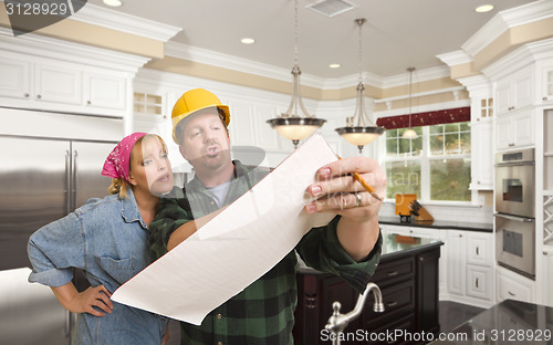 Image of Contractor Discussing Plans with Woman Inside Custom Kitchen Int