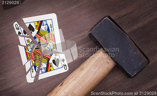 Image of Hammer with a broken card, queen of spades