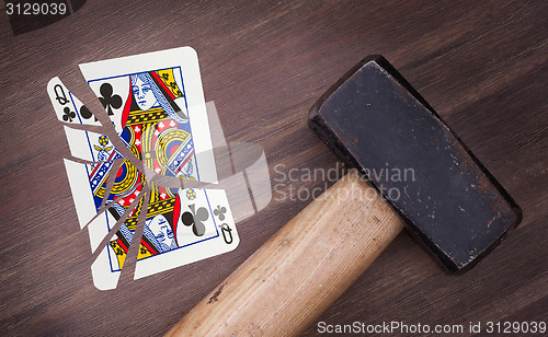 Image of Hammer with a broken card, queen of clubs