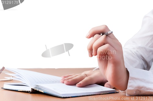 Image of Hands of reflected business lady over organizer