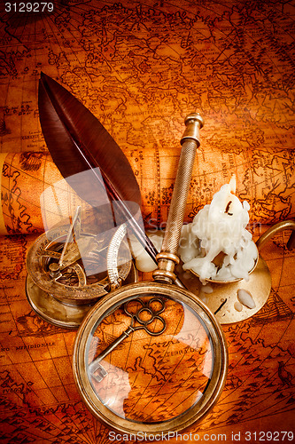 Image of Vintage still life. Vintage items on ancient map.