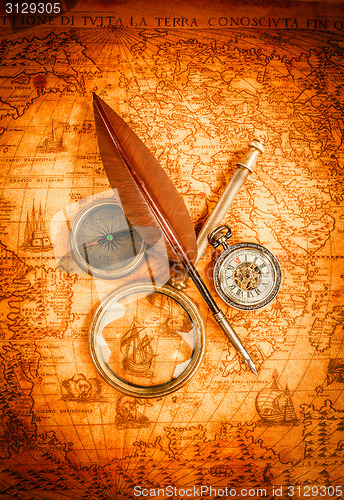 Image of Vintage magnifying glass lies on an ancient world map