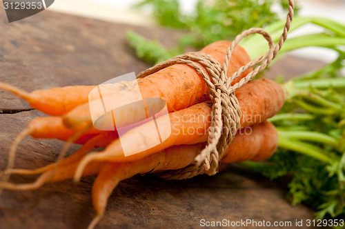 Image of baby carrots bunch tied with rope