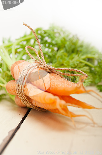 Image of baby carrots bunch tied with rope