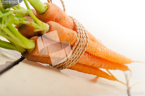 Image of baby carrots bunch tied with rope