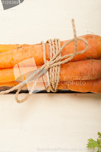 Image of baby carrots bunch tied with rope