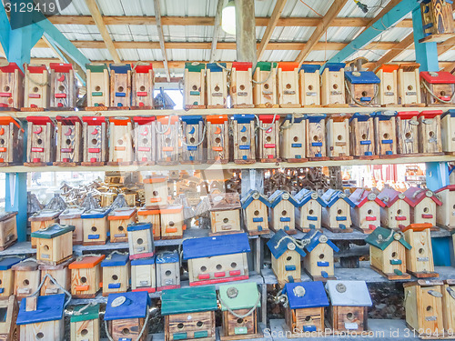 Image of array of handmade birdhouses for sale