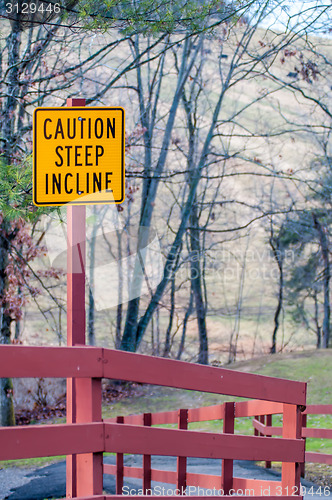 Image of caution steep incline warning yellow sign