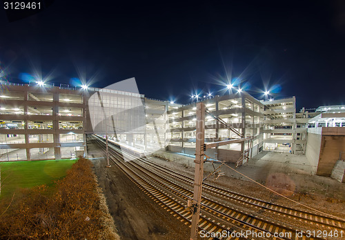 Image of electro train intermodal terminal with parking at night